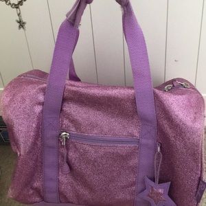 purple sparkly mini duffel bag .